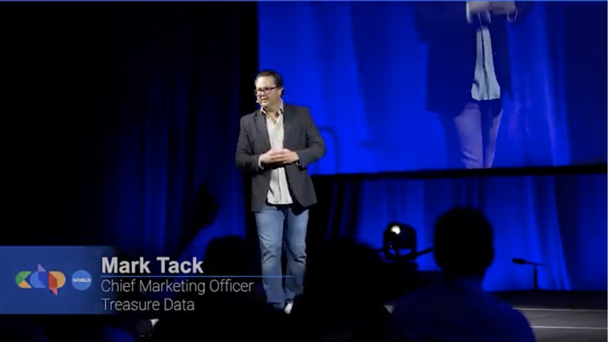 Mark Tack speaking on stage at CDP World